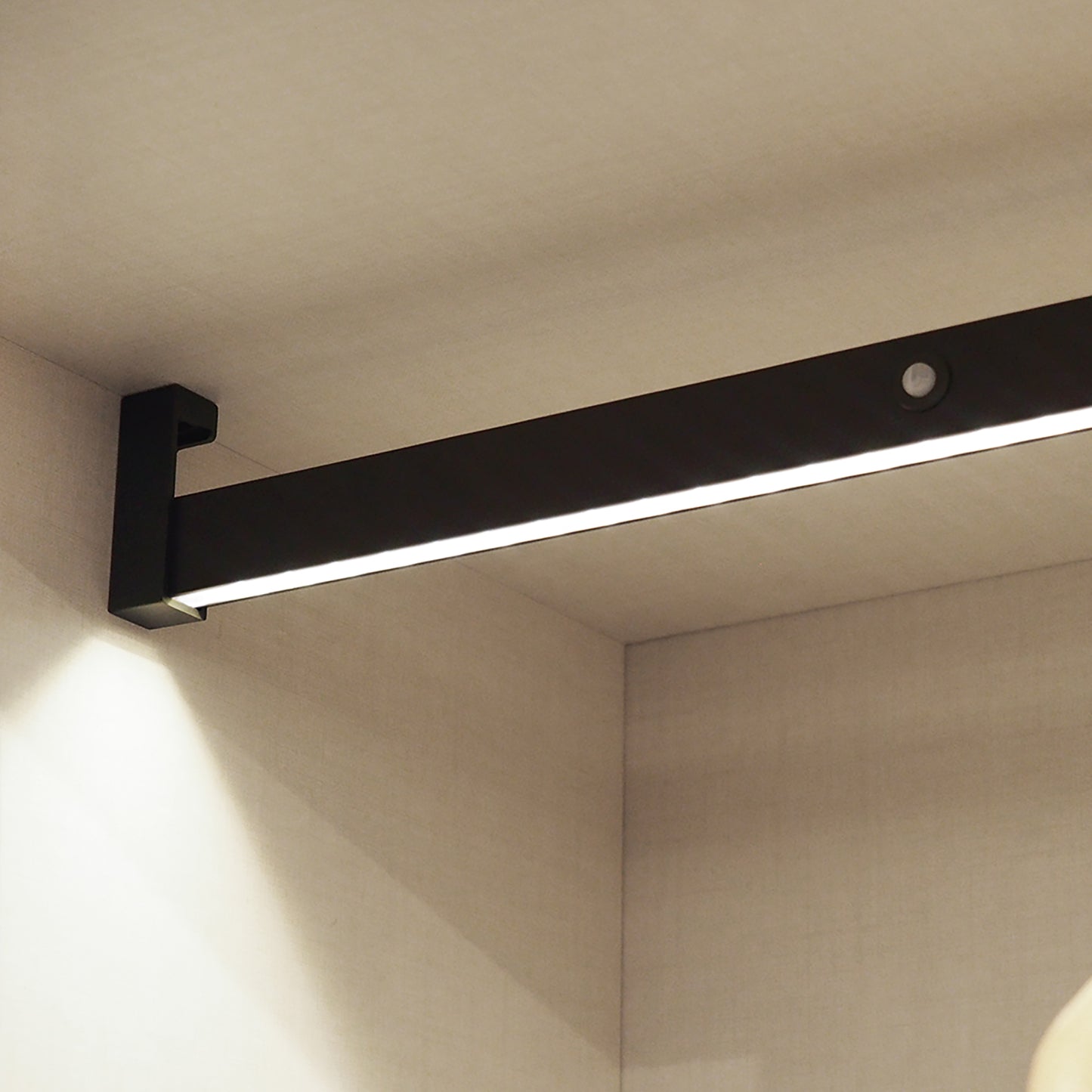 Castor LED closet rail with light, removable battery and motion sensor, painted mocha/anodized